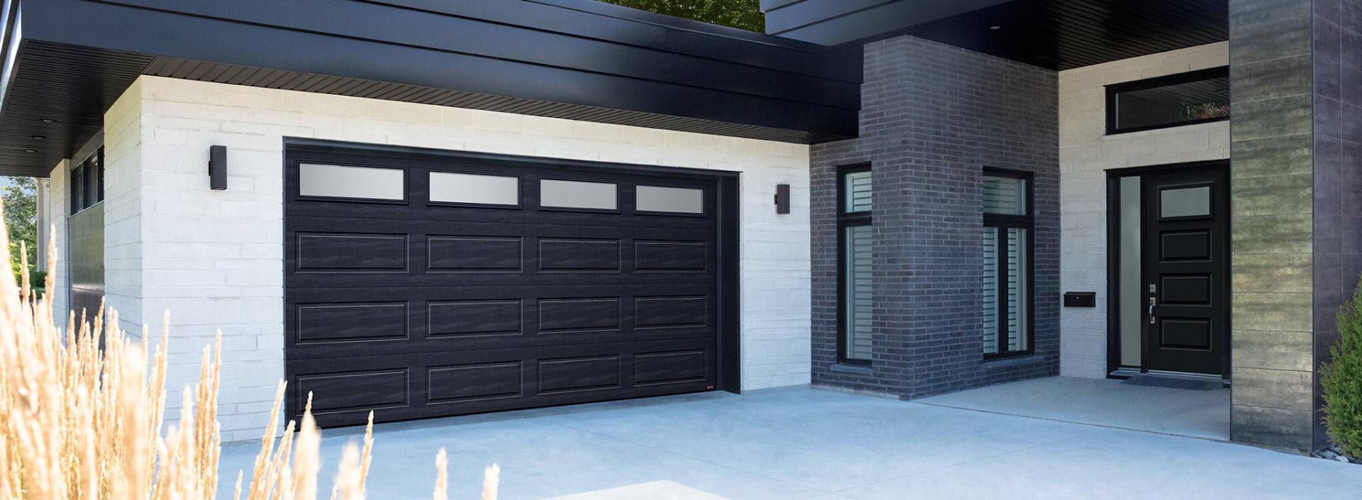 Contemporary modern grey and black house with a black garage door Standard+ Shaker-Modern XL with windows on top and matching entry Novatech door